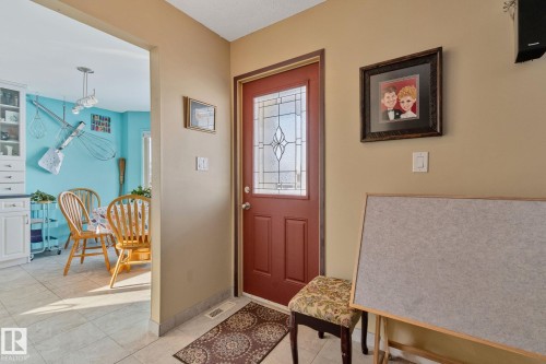 Foyer entrance with light tile patterned flooring and baseboards - 4231 39 Avenue, Leduc, AB - Indoor Photo Showing Other Room