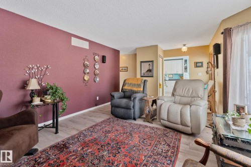 Living room with light wood-style floors and a textured ceiling - 4231 39 Avenue, Leduc, AB - Indoor Photo Showing Living Room