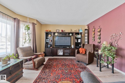 Living room featuring light wood-style floors and a textured ceiling - 4231 39 Avenue, Leduc, AB - Indoor Photo Showing Living Room