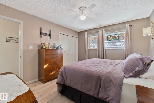 Bedroom with wood finished floors, a closet, a ceiling fan, and a textured ceiling - 4231 39 Avenue, Leduc, AB - Indoor Photo Showing Bedroom