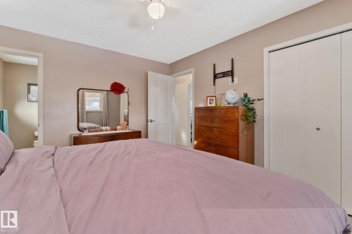 Bedroom with a textured ceiling, a closet, and ceiling fan - 4231 39 Avenue, Leduc, AB - Indoor Photo Showing Bedroom