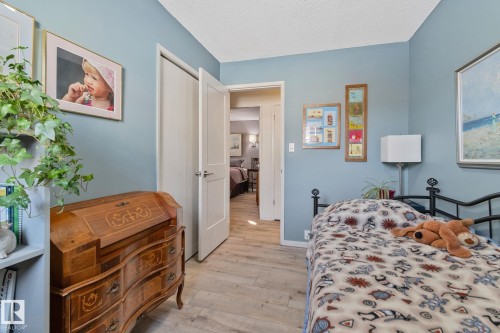 Bedroom featuring light wood-style floors and a textured ceiling - 4231 39 Avenue, Leduc, AB - Indoor Photo Showing Bedroom