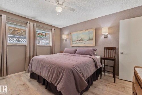 Bedroom featuring light wood-style floors, ceiling fan, and a textured ceiling - 4231 39 Avenue, Leduc, AB - Indoor Photo Showing Bedroom