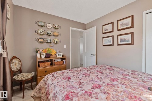 Bedroom featuring light wood-style flooring and a textured ceiling - 4231 39 Avenue, Leduc, AB - Indoor Photo Showing Bedroom