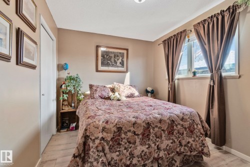 Bedroom featuring light wood-style floors and baseboards - 4231 39 Avenue, Leduc, AB - Indoor Photo Showing Bedroom