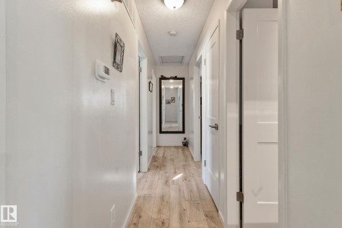 Corridor with a textured ceiling and light wood finished floors - 4231 39 Avenue, Leduc, AB - Indoor Photo Showing Other Room