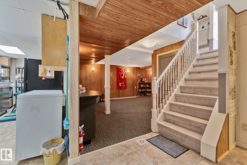 Staircase featuring wooden walls, carpet floors, and wooden ceiling - 4231 39 Avenue, Leduc, AB - Indoor Photo Showing Other Room