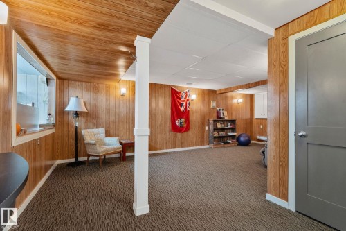 Interior space featuring wooden walls and carpet flooring - 4231 39 Avenue, Leduc, AB - Indoor Photo Showing Other Room