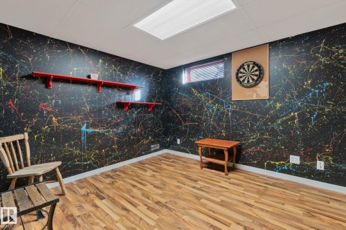 Game room featuring wood finished floors and baseboards - 4231 39 Avenue, Leduc, AB - Indoor Photo Showing Other Room
