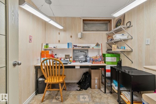 Office featuring wooden walls and built in desk - 4231 39 Avenue, Leduc, AB - Indoor Photo Showing Other Room