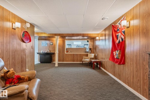 Hall with carpet and wood walls - 4231 39 Avenue, Leduc, AB - Indoor Photo Showing Other Room