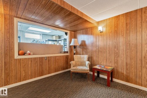 Sitting room with wooden walls and carpet - 4231 39 Avenue, Leduc, AB - Indoor Photo Showing Other Room