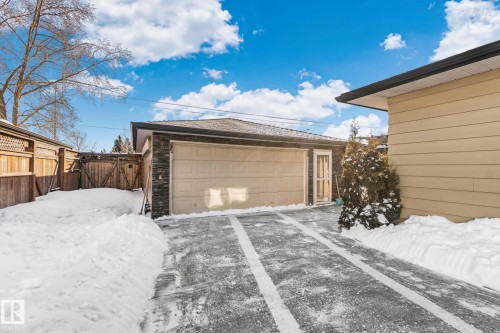 Snow covered garage featuring a detached garage and a gate - 4231 39 Avenue, Leduc, AB - Outdoor With Exterior
