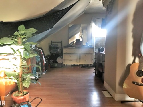 Additional living space featuring vaulted ceiling and wood finished floors - 4735 48 Ave, Evansburg, AB - Indoor Photo Showing Other Room