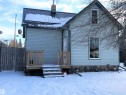 Snow covered property featuring a chimney and a metal roof - 4735 48 Ave, Evansburg, AB  - Outdoor 