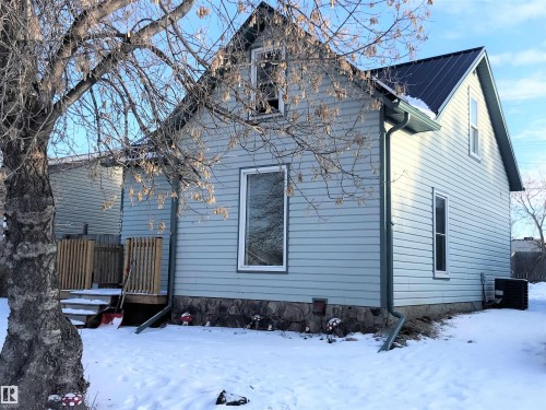 View of snowy exterior with a deck and a central AC unit - 4735 48 Ave, Evansburg, AB - Outdoor
