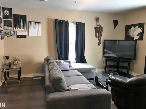 Living room featuring baseboards and wood finished floors - 4735 48 Ave, Evansburg, AB - Indoor Photo Showing Living Room