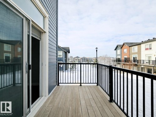 Wooden deck featuring a residential view - 129 2560 Pegasus Boulevard, Edmonton, AB - Outdoor With Balcony With Exterior
