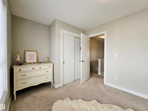 Bedroom with light colored carpet and a closet - 129 2560 Pegasus Boulevard, Edmonton, AB - Indoor Photo Showing Bedroom