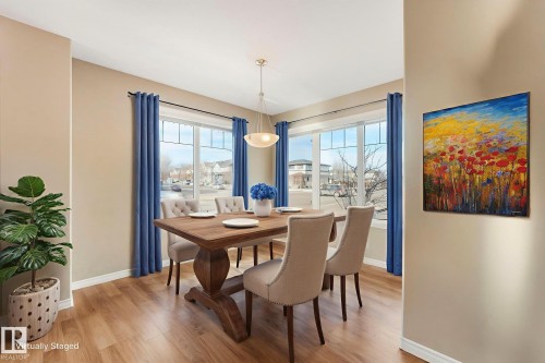 Dining space featuring light wood-type flooring and baseboards - 385 Secord Boulevard, Edmonton, AB - Indoor Photo Showing Dining Room