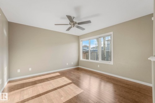 Spacious room with wood-type flooring and ceiling fan - 385 Secord Boulevard, Edmonton, AB - Indoor Photo Showing Other Room