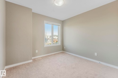 Unfurnished room featuring light colored carpet and baseboards - 385 Secord Boulevard, Edmonton, AB - Indoor Photo Showing Other Room
