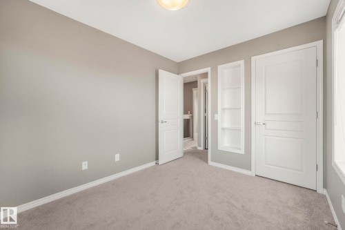 Unfurnished bedroom 2 featuring baseboards and carpet flooring, nook & closet - 385 Secord Boulevard, Edmonton, AB - Indoor Photo Showing Other Room