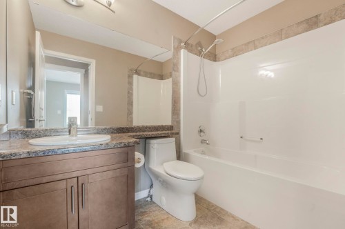Full bathroom with vanity, tub / shower combination, and light tile patterned floors - 385 Secord Boulevard, Edmonton, AB - Indoor Photo Showing Bathroom