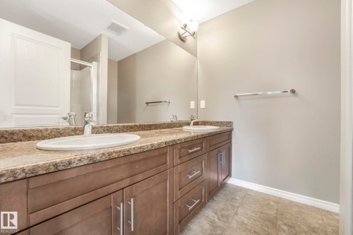 Bathroom featuring a stall shower, double vanity, and light tile patterned flooring - 385 Secord Boulevard, Edmonton, AB - Indoor Photo Showing Bathroom