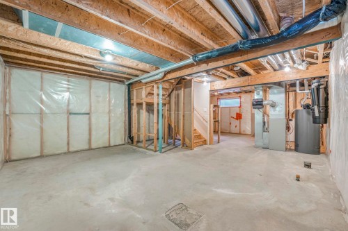 Unfinished basement featuring heating unit and water heater - 385 Secord Boulevard, Edmonton, AB - Indoor Photo Showing Basement