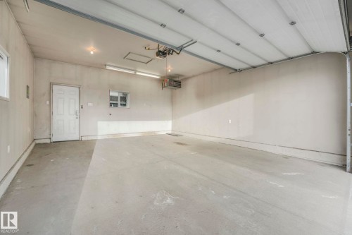 Garage with a heating unit - 385 Secord Boulevard, Edmonton, AB - Indoor Photo Showing Garage