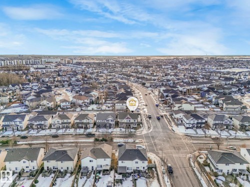Aerial perspective of suburban area showing the school and pond in the near distance. - 385 Secord Boulevard, Edmonton, AB - Outdoor With View