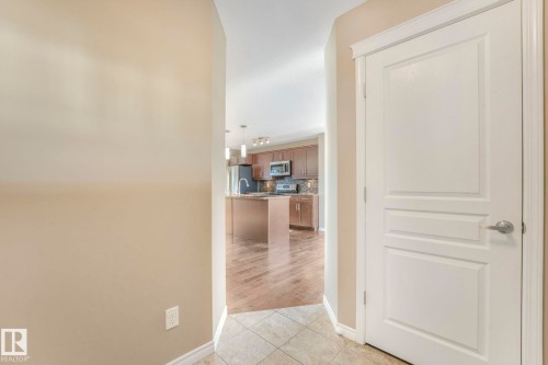 Hallway with light tile patterned flooring and baseboards - 385 Secord Boulevard, Edmonton, AB - Indoor Photo Showing Other Room