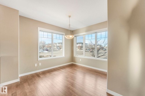 Unfurnished dining area with light wood-style flooring and baseboards - 385 Secord Boulevard, Edmonton, AB - Indoor Photo Showing Other Room