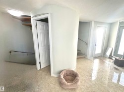 Hall with a textured ceiling and stairs - 