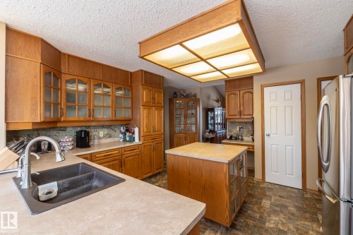 Plenty of cupboards, upper and lower with a place for everything!  Eating area in the kitchen has great views to the West side of the property.  Easy access too, to the dining room whether table service or buffet style, meals are easy peasy! - 57524 Range Road 270, Rural Westlock County, AB - Indoor Photo Showing Kitchen With Double Sink