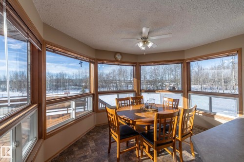 No matter what meal you're having, enjoy it HERE. Loads of natural light and plenty of elbow room. Great spot to bird watch, or maybe get a visit from wildlife....enjoy! - 57524 Range Road 270, Rural Westlock County, AB - Indoor Photo Showing Dining Room
