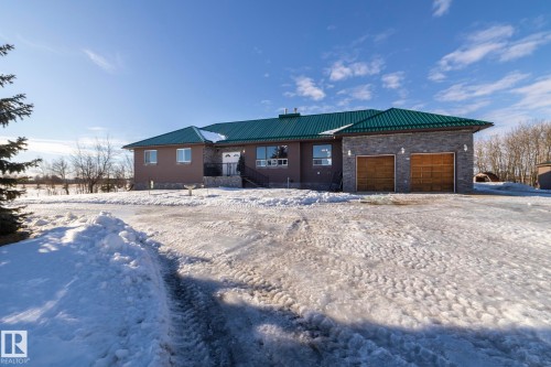 View of the front of the home, from the driveway entrance, approaching the circular driveway - 57524 Range Road 270, Rural Westlock County, AB - Outdoor