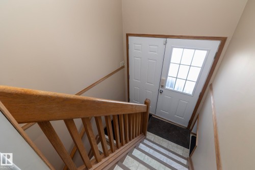 This stairway is located in the hallway, just off the kitchen & entry from garage.  Exterior door leads to the concrete patio.   Let's see where the stairs lead to.......... - 57524 Range Road 270, Rural Westlock County, AB - Indoor Photo Showing Other Room