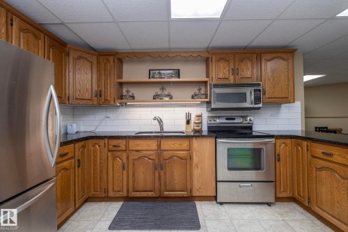 Enter the lower level where you are greeted with a full kitchen including a 2nd set of stainless appliances!  Works perfectly for modern family living situations whether multi-generational, blended OR simply have out of towners, staying a while...More.... - 57524 Range Road 270, Rural Westlock County, AB - Indoor Photo Showing Kitchen