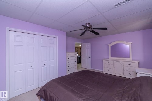 1 of 2  large bedrooms downstairs. Plenty of clost space!  Window is above grade & allows afternoon sunshine--West facing--to bring in additional light. More than adequate space, no matter what age. - 57524 Range Road 270, Rural Westlock County, AB - Indoor Photo Showing Bedroom