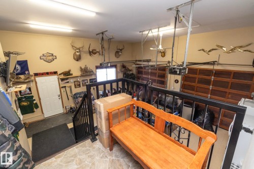 The doorway here is from hallway, near kitchen, taking you to the double attached heated garage--Currently it is the "Man Cave" ! A few steps down to the concrete. Side entry to additional parking. 2 o/head doors with openers. 8' height. Furnace/sink. - 57524 Range Road 270, Rural Westlock County, AB - Indoor