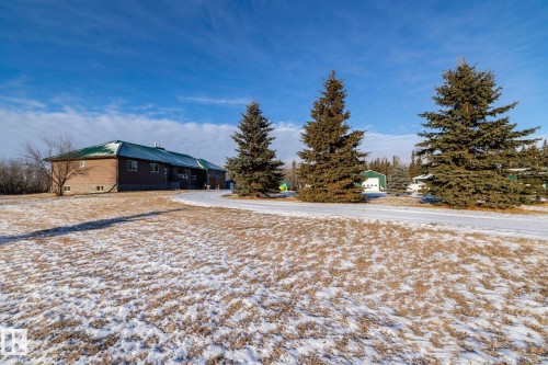 Looking toward the house from pond side, Spruce trees are along the circular driveway - 57524 Range Road 270, Rural Westlock County, AB - Outdoor