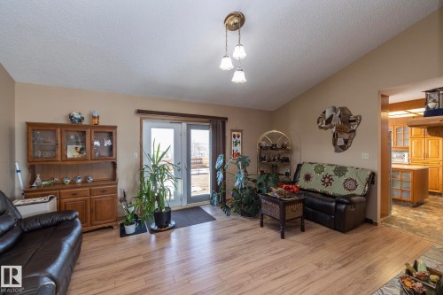 Relaxing and cozy yet open and airy too. This room shares the 2 sided fireplace with the living room and it also has garden doors which lead to the huge West facing deck. This home has plenty of living and entertaining space, inside and out! - 57524 Range Road 270, Rural Westlock County, AB - Indoor Photo Showing Living Room