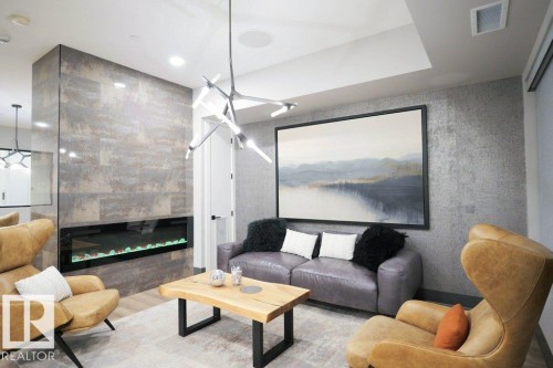 101 7471 May Common, Edmonton, AB - Indoor Photo Showing Living Room With Fireplace