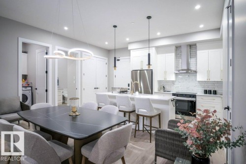 Dining area featuring recessed lighting, washer / dryer, and light wood finished floors - 101 7471 May Common, Edmonton, AB - Indoor Photo Showing Other Room