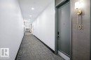Hallway featuring dark colored carpet and recessed lighting - 101 7471 May Common, Edmonton, AB  - Indoor Photo Showing Other Room 