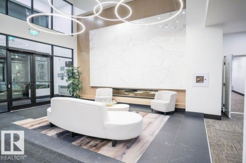 Community lobby with a towering ceiling - 101 7471 May Common, Edmonton, AB - Indoor Photo Showing Other Room