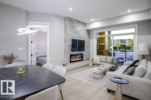 101 7471 May Common, Edmonton, AB - Indoor Photo Showing Living Room With Fireplace