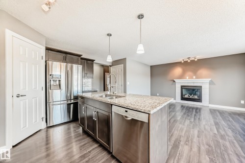3520 49 Avenue, Beaumont, AB - Indoor Photo Showing Kitchen With Fireplace With Double Sink With Upgraded Kitchen